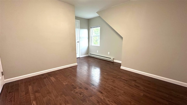 674 Sackett Lake Rd, Monticello, NY 12701 - additional living space with a baseboard heating unit, dark wood-type flooring, and baseboards