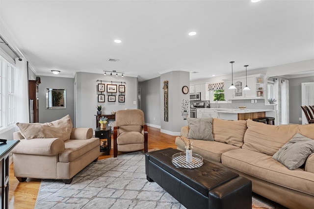 7 Lincoln Dr, Washingtonville, NY 10992 - living area with light wood-style floors, recessed lighting, crown molding, and baseboards