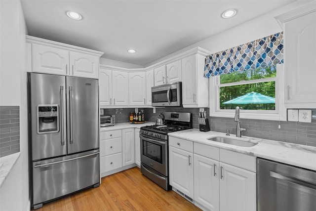 7 Lincoln Dr, Washingtonville, NY 10992 - kitchen featuring stainless steel appliances, a sink, white cabinetry, and recessed lighting
