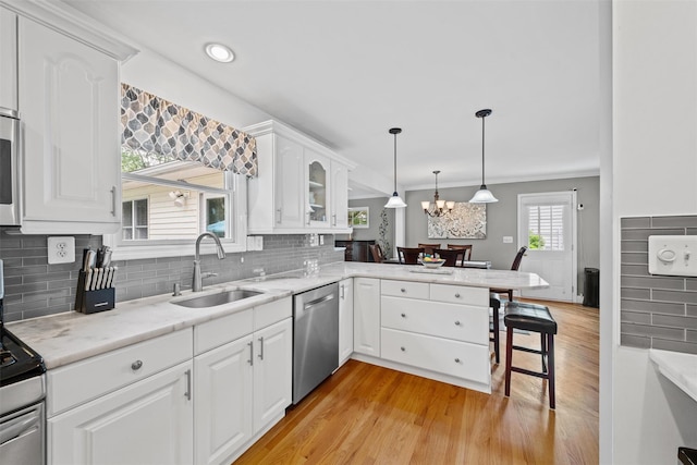 7 Lincoln Dr, Washingtonville, NY 10992 - kitchen with appliances with stainless steel finishes, a sink, a chandelier, light wood-type flooring, and recessed lighting