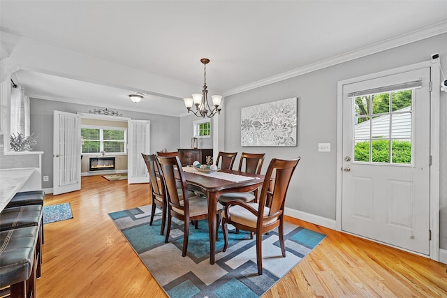 7 Lincoln Dr, Washingtonville, NY 10992 - dining space featuring light wood finished floors, baseboards, crown molding, and a chandelier