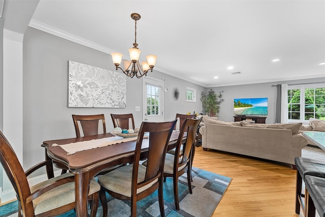 7 Lincoln Dr, Washingtonville, NY 10992 - dining space with light wood finished floors, a chandelier, recessed lighting, healthy amount of natural light, and crown molding