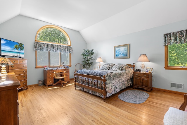50 Stallion Trl, Brewster, NY 10509 - bedroom with vaulted ceiling, multiple windows, and wood finished floors