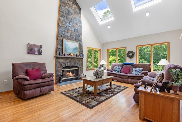 50 Stallion Trl, Brewster, NY 10509 - living room with high vaulted ceiling, a skylight, wood finished floors, a fireplace, and recessed lighting
