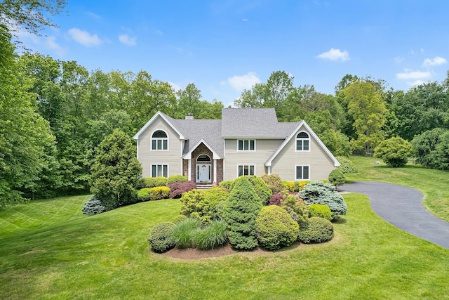 50 Stallion Trl, Brewster, NY 10509 - view of front facade with a front yard and a chimney