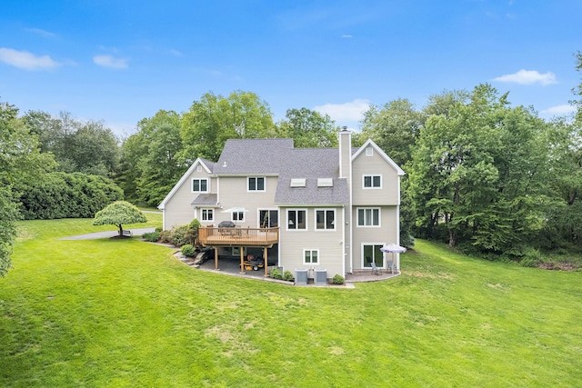 50 Stallion Trl, Brewster, NY 10509 - rear view of property featuring a wooden deck, a chimney, a patio, and a yard