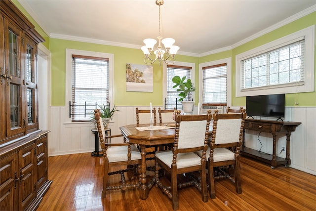 11 Bridge St, Suffern, NY 10901 - dining area featuring a wainscoted wall, hardwood / wood-style flooring, a chandelier, ornamental molding, and a decorative wall