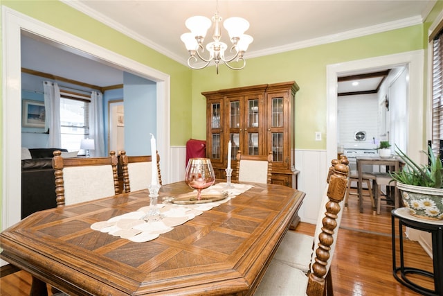 11 Bridge St, Suffern, NY 10901 - dining area with a chandelier, wainscoting, crown molding, and wood finished floors