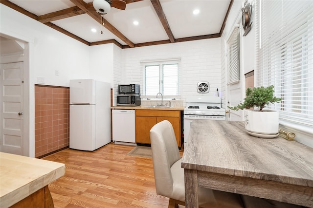 11 Bridge St, Suffern, NY 10901 - kitchen with white appliances, tile walls, light wood-style flooring, beamed ceiling, and a ceiling fan