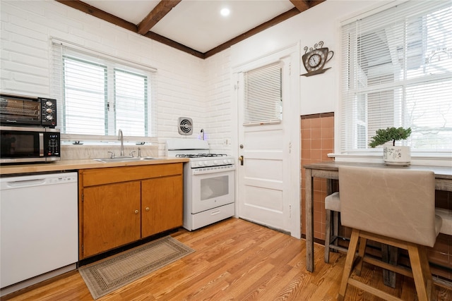 11 Bridge St, Suffern, NY 10901 - kitchen with white appliances, light wood-style flooring, plenty of natural light, light countertops, and tile walls