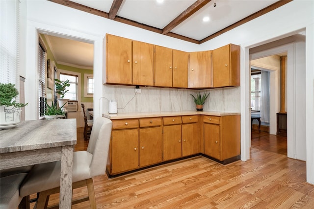 11 Bridge St, Suffern, NY 10901 - kitchen featuring light wood-type flooring, light countertops, decorative backsplash, brown cabinets, and beam ceiling