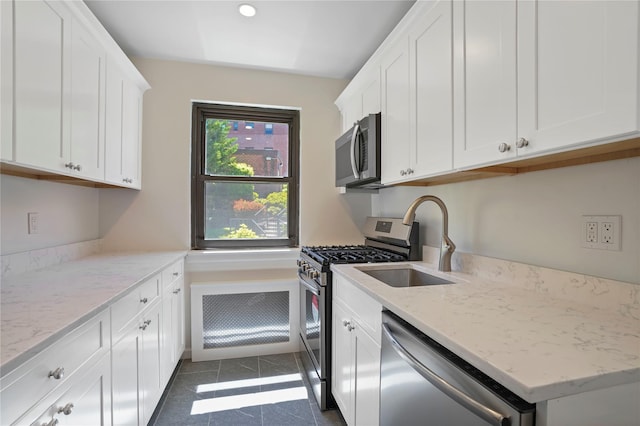 127 Beacon Hill Dr Unit F 13, Dobbs Ferry, NY 10522 - kitchen featuring stainless steel appliances, a sink, white cabinetry, and dark tile patterned flooring