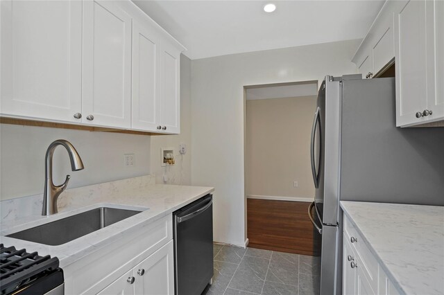 127 Beacon Hill Dr Unit F 13, Dobbs Ferry, NY 10522 - kitchen with dishwashing machine, a sink, white cabinets, freestanding refrigerator, and light stone countertops