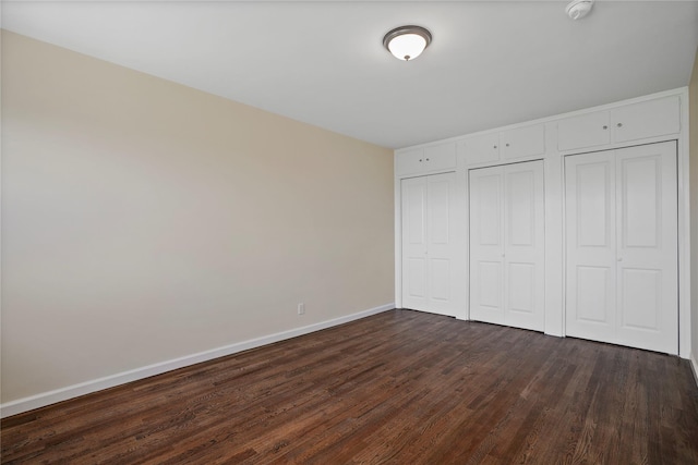 127 Beacon Hill Dr Unit F 13, Dobbs Ferry, NY 10522 - unfurnished bedroom featuring dark wood-style floors, two closets, and baseboards