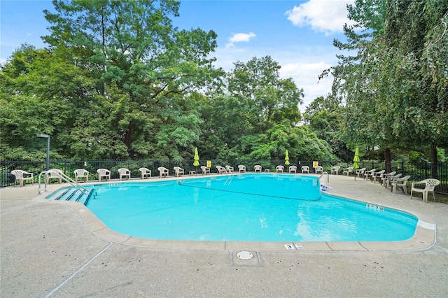 127 Beacon Hill Dr Unit F 13, Dobbs Ferry, NY 10522 - community pool with a patio area and view of scattered trees