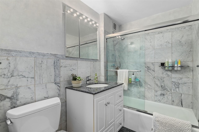 25 Lake St Unit 7K & 7L, White Plains, NY 10603 - full bath featuring toilet, vanity, bath / shower combo with glass door, and tile walls