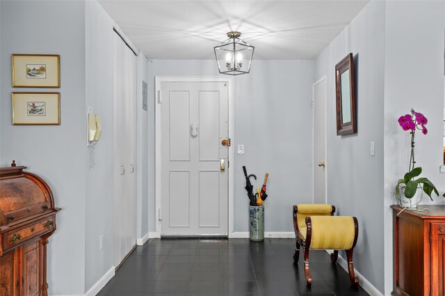 25 Lake St Unit 7K & 7L, White Plains, NY 10603 - entrance foyer featuring baseboards, dark tile patterned flooring, and a chandelier