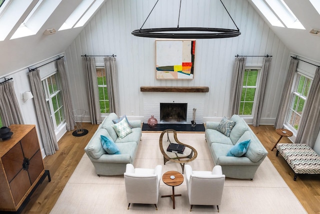 149 Washington Spring Rd, Palisades, NY 10964 - living room with a skylight, wood finished floors, a fireplace, high vaulted ceiling, and wood walls