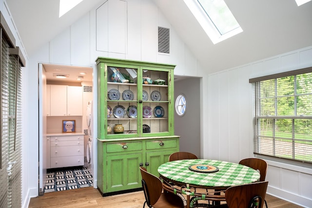 149 Washington Spring Rd, Palisades, NY 10964 - dining room with a skylight, lofted ceiling, light wood finished floors, and a decorative wall