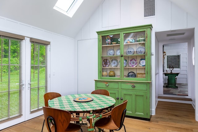 149 Washington Spring Rd, Palisades, NY 10964 - dining room with vaulted ceiling, a skylight, and light wood-style flooring