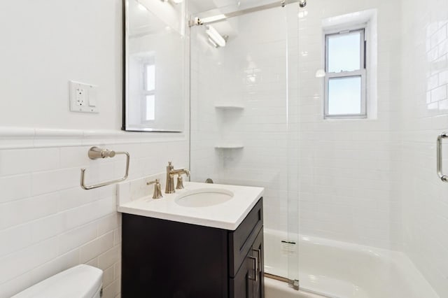 565 Broadway Unit 6B, Hastings-On-Hudson, NY 10706 - bathroom featuring tile walls, toilet, enclosed tub / shower combo, and vanity