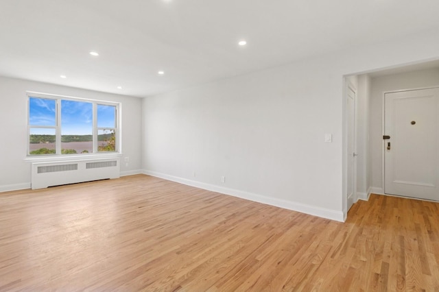 565 Broadway Unit 6B, Hastings-On-Hudson, NY 10706 - empty room featuring radiator heating unit, light wood finished floors, recessed lighting, and baseboards