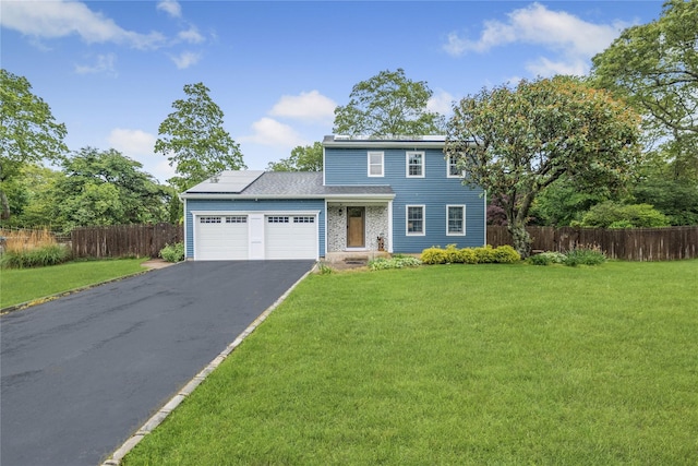5 Cedar Heights Dr, Ridge, NY 11961 - traditional home with an attached garage, asphalt driveway, and solar panels