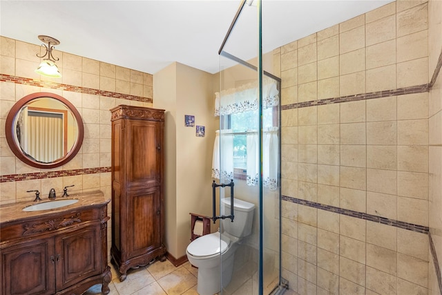 5 Cedar Heights Dr, Ridge, NY 11961 - full bathroom featuring vanity, a stall shower, toilet, tile patterned flooring, and tile walls