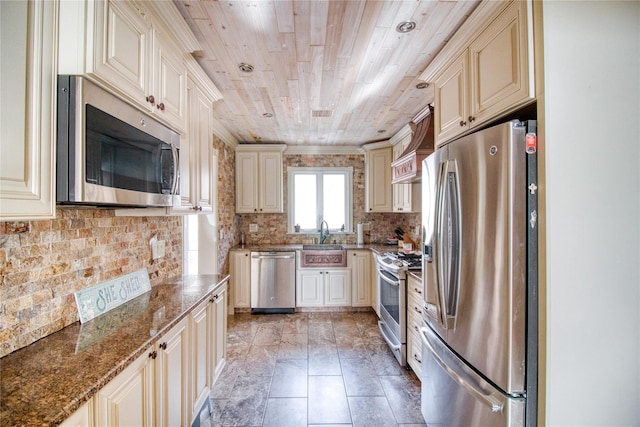 102 Barbara St, Staten Island, NY 10306 - kitchen featuring appliances with stainless steel finishes, cream cabinetry, wooden ceiling, a sink, and tasteful backsplash