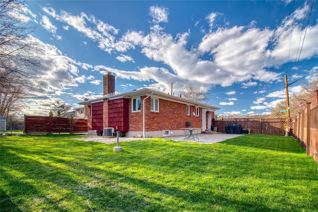 102 Barbara St, Staten Island, NY 10306 - back of house featuring a chimney, a patio, brick siding, and cooling unit