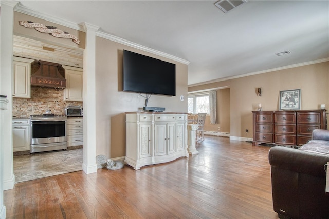102 Barbara St, Staten Island, NY 10306 - living area featuring light wood-type flooring, crown molding, baseboards, and a baseboard radiator