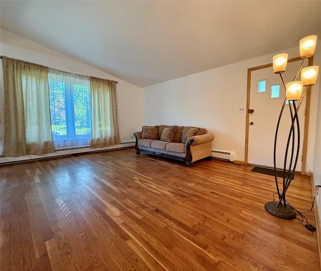 123 Helene Rd, Valley Cottage, NY 10989 - living area with a baseboard heating unit, wood finished floors, lofted ceiling, and plenty of natural light