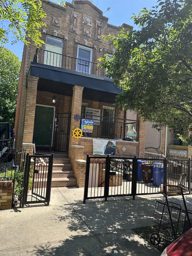 419 Van Siclen Ave, Brooklyn, NY 11207 - view of front of home featuring brick siding and a gate