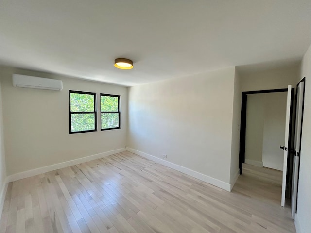 69-14 198th St, Fresh Meadows, NY 11365 - empty room with a wall mounted air conditioner, light wood-style floors, and baseboards