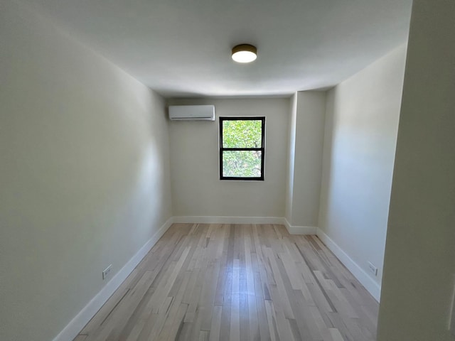69-14 198th St, Fresh Meadows, NY 11365 - unfurnished room featuring a wall unit AC, light wood-type flooring, and baseboards