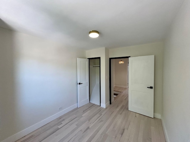 69-14 198th St, Fresh Meadows, NY 11365 - unfurnished bedroom featuring light wood-style floors, baseboards, and a closet