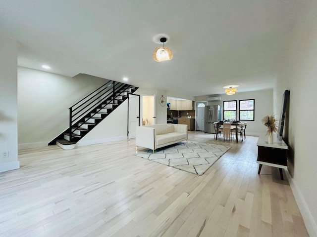 69-14 198th St, Fresh Meadows, NY 11365 - living area with stairway, baseboards, light wood finished floors, and recessed lighting