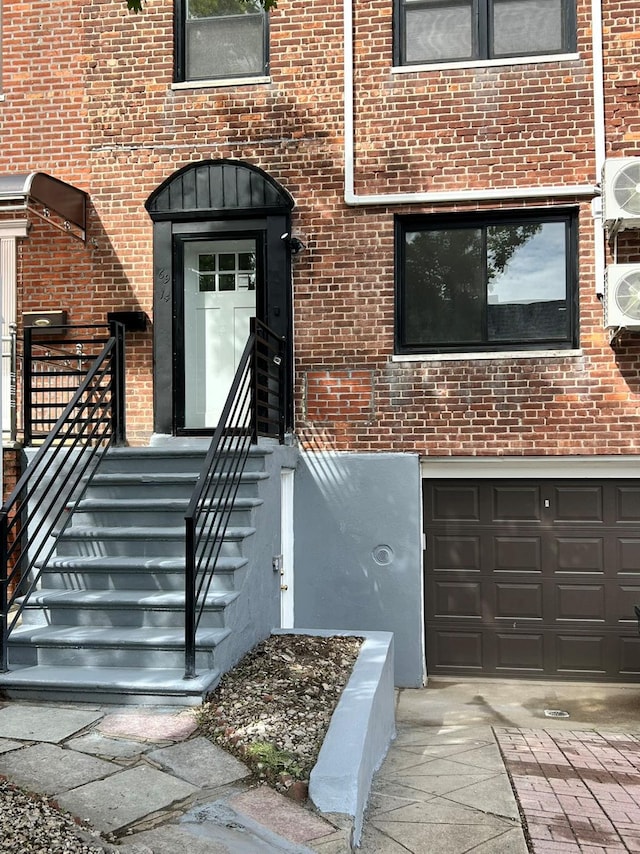 69-14 198th St, Fresh Meadows, NY 11365 - doorway to property featuring brick siding and an attached garage