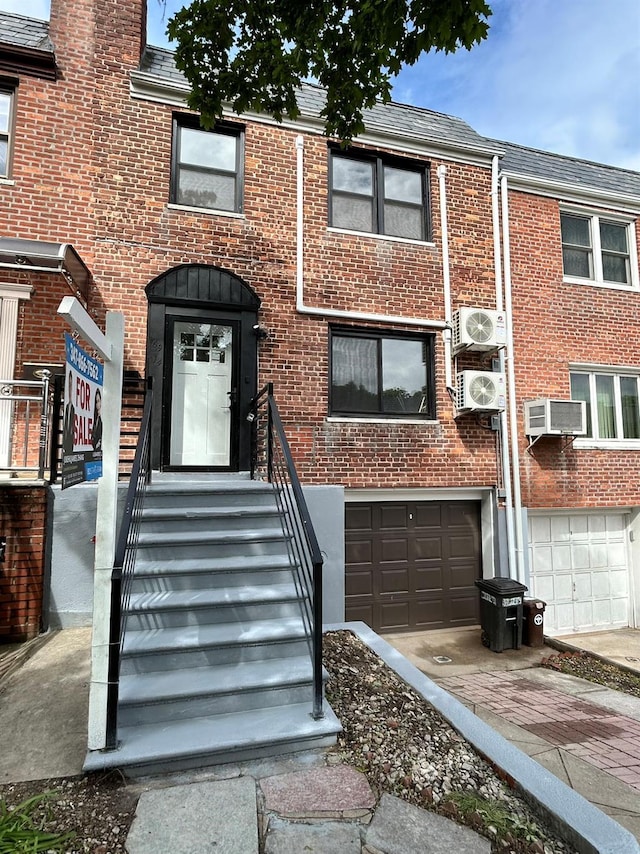 69-14 198th St, Fresh Meadows, NY 11365 - view of property with a cooling unit, brick siding, an attached garage, and driveway