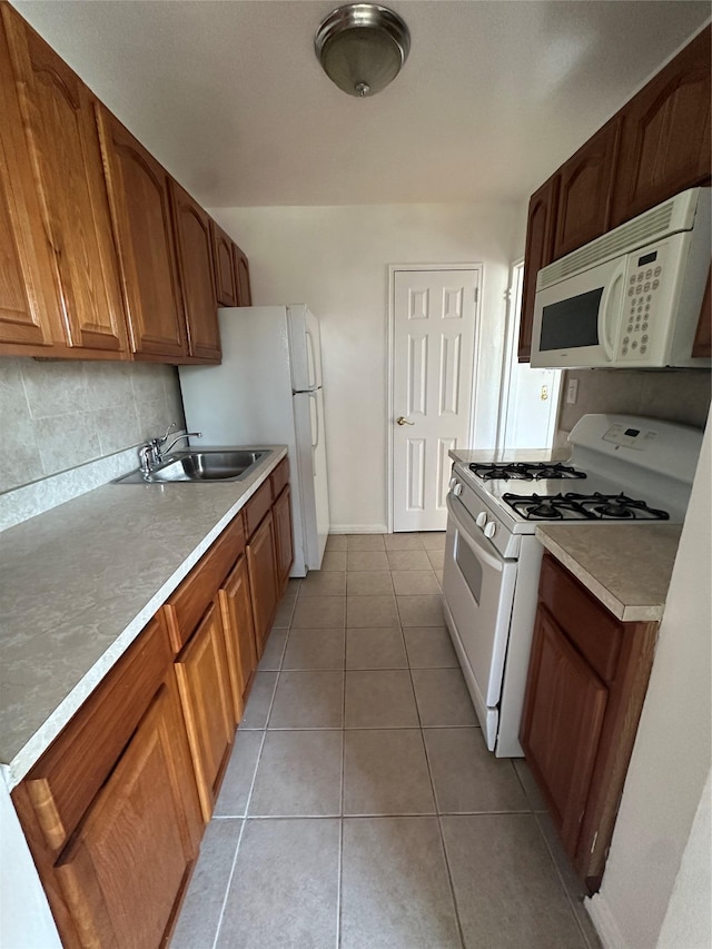 610 Waring Ave Unit 5G, Bronx, NY 10467 - kitchen featuring white appliances, a sink, tasteful backsplash, brown cabinets, and light countertops