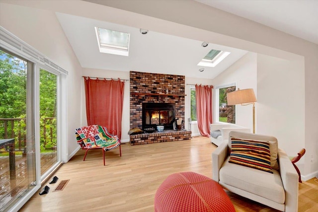 13 Romar Ave, White Plains, NY 10605 - living room featuring vaulted ceiling, a skylight, light wood-style flooring, a brick fireplace, and baseboards