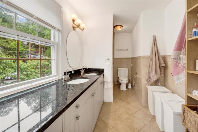 13 Romar Ave, White Plains, NY 10605 - full bathroom featuring tile patterned floors, double vanity, toilet, a wainscoted wall, and tile walls