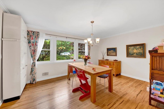 13 Romar Ave, White Plains, NY 10605 - dining space with a chandelier, baseboards, crown molding, and light wood-style flooring
