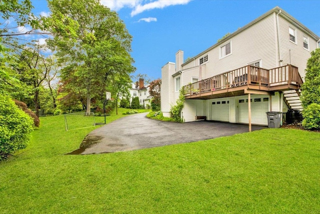 13 Romar Ave, White Plains, NY 10605 - rear view of property with asphalt driveway, a yard, a wooden deck, and an attached garage