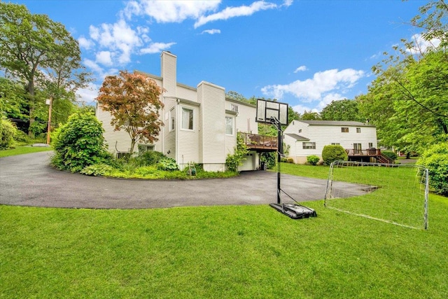 13 Romar Ave, White Plains, NY 10605 - rear view of property with a deck, a lawn, a chimney, and driveway