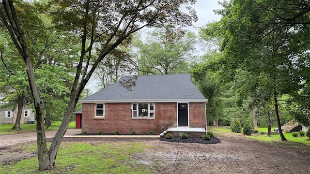 20 Pineview Rd, West Nyack, NY 10994 - view of front of house featuring brick siding, a shingled roof, and driveway