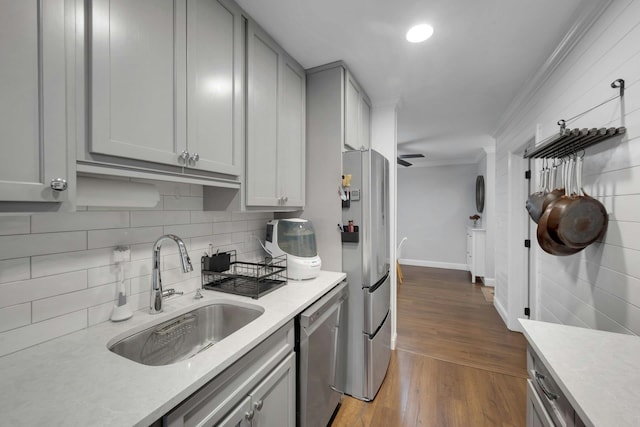 1 Vincent Rd Unit 2B, Bronxville, NY 10708 - kitchen featuring appliances with stainless steel finishes, a sink, crown molding, gray cabinetry, and light countertops