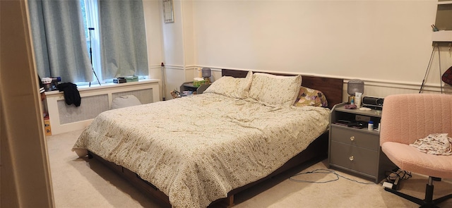 11514 135th Ave, Ozone Park, NY 11420 - bedroom featuring light carpet, radiator, and wainscoting