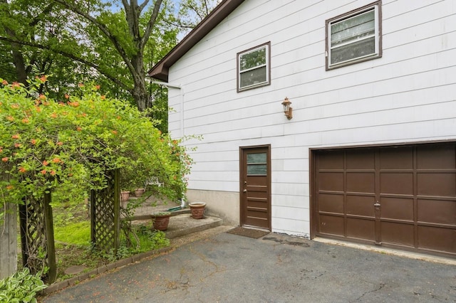 18 Norwood Pl, Nanuet, NY 10954 - view of side of home with a garage and asphalt driveway
