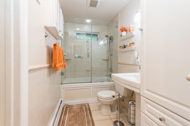 18 Norwood Pl, Nanuet, NY 10954 - bathroom with toilet, baseboard heating, tile patterned flooring, combined bath / shower with glass door, and tile walls